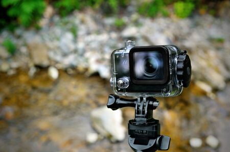 Action waterproof camera on mountain river backgroundの写真素材