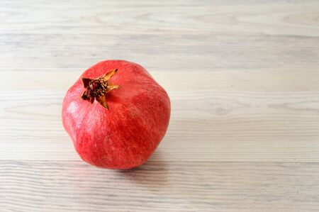 sweet pomegranates on white wood table backgroundの写真素材