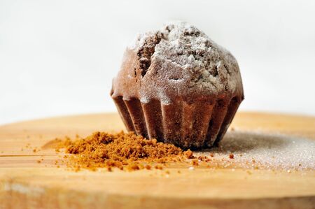 tasty cupcake on wooden board with white backgroundの写真素材