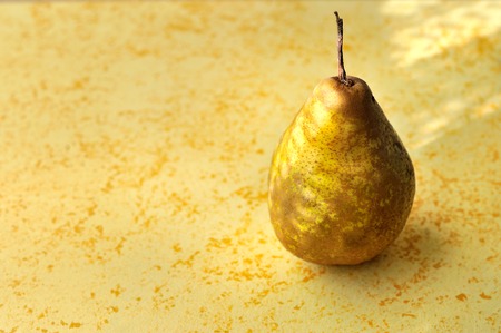 Pear on golden textured backgroundの写真素材