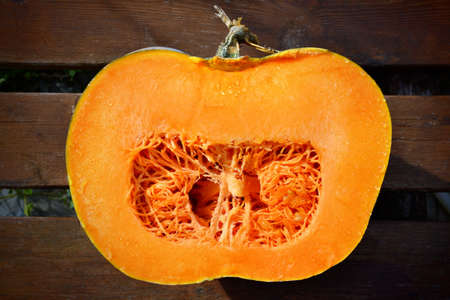 Fresh pumpkin cutting in half, isolated on a white.