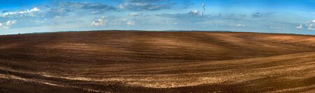 Panorama of arable land over amazing cloudsの写真素材