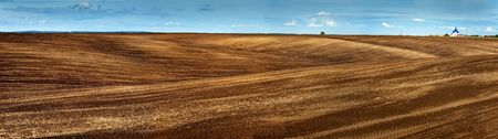 Lines of arable land landscape panoramic viewの写真素材