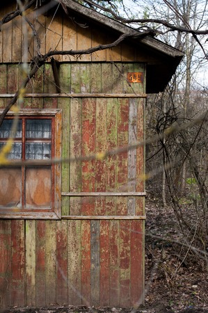 tiny house or shed at a plot of an allotment. Early spring time. Small shack in spring gardenの写真素材