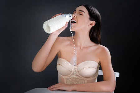 young brunette model in lingerie with milk bottleの写真素材