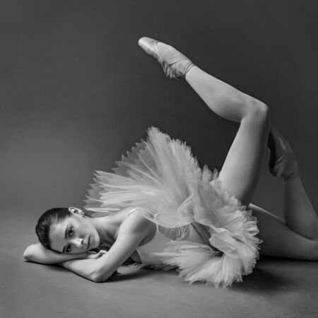 young ballerina on the floor of the studio lying downの写真素材