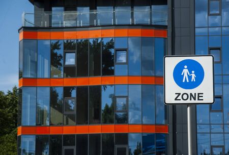 pedestrian zone sign on the background of modern glass facadesの写真素材