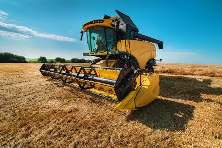 close view of modern combine harvester in action. Harvesting and arable industry in Ukraineの写真素材