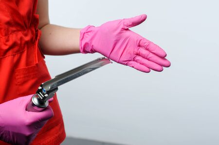 medic in gloves holds in his hands a medical instrument, paramedicの写真素材