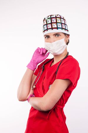 Female attractive doctor with mask and stethoscope standing on white backgroundの写真素材