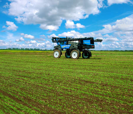 Mostys'kyi district, Lviv region, Ukraine - September 05, 2019: Agricultural machinery presentation - New Holland SP.275F self-propelled sprayer in the field, winter crop fertilizers, spring crop fertilizersのeditorial素材