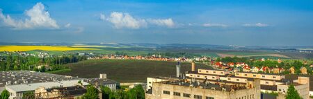 panorama of borders city Arable lands of village near blooming rapefieldの写真素材