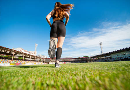 girl running, legs close up, bottom view from the back