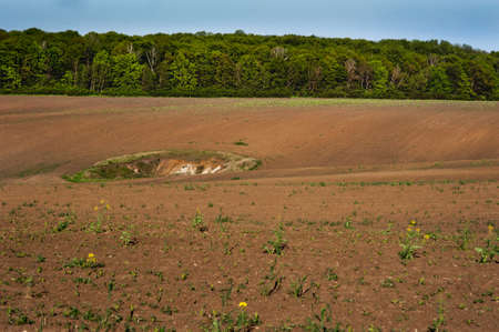 Geological funnel on a plowed field