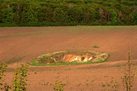 Geological funnel on a plowed fieldの写真素材