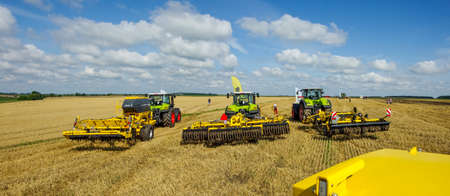 TERNOPIL REGION, UKRAINE - August 10, 2021: tractors with trailed harrows at the demonstration of agricultural machinery, exhibition of the company "Lan"のeditorial素材