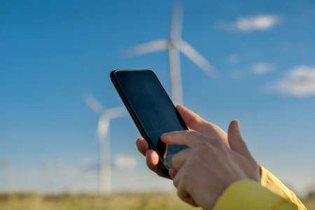 gadget with a program for monitoring technical parameters in focus in human hands on a blurred...