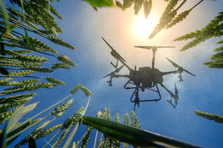 A sprayer drone flies over a wheatfield. Smart farming and precision farmingの写真素材