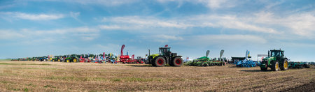 Bilogirya, Khmelnytsky region, UKRAINE - August 19, 2021: tractors with seeder at the demonstration of agricultural machinery, exhibition "Battle of agrotitans" seeder competitionのeditorial素材