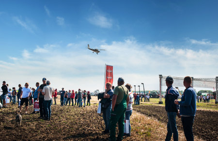 Bilogirya, Khmelnytsky region, UKRAINE - August 19, 2021: at the demonstration of agricultural machinery, exhibition "Battle of agrotitans" seeder competition, and airplan at skyのeditorial素材