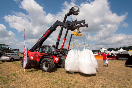 Belogorye, Khmelnytsky region, UKRAINE - August 19, 2021: Loader Manitou with bags of seeds at the...