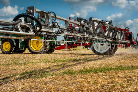 Belogorye, Khmelnytsky region, UKRAINE - August 19, 2021: tractor with trailed sprayer fertilizer on...