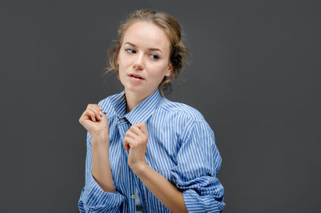 a woman in a striped shirt on a gray background, casual clothes,の写真素材