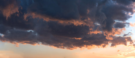 An epic sunset with colorful clouds lit by the sun. textured sky photo. A picturesque image of...
