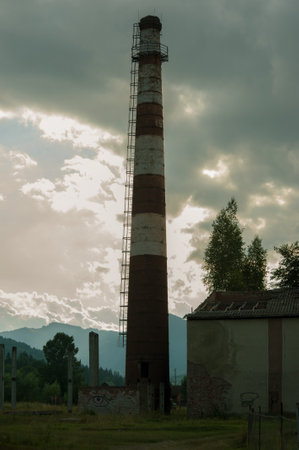 an abandoned former factory, a tall chimney, in the mountains, the decline of an industrial building in the Carpathiansの写真素材