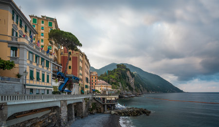 The picturesque colorful houses against a backdrop of mountains at Mediterranean coast, Camogli, Liguria, Italy.の写真素材