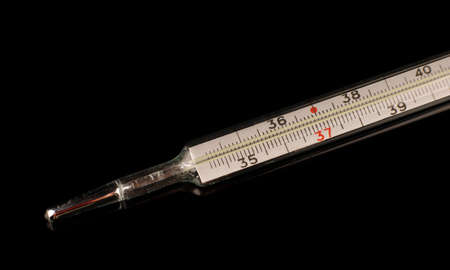 Medical mercury thermometer on a black isolate background