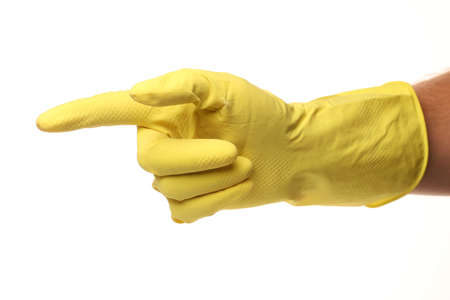 A hand in a yellow cleaner glove points to something place for text cope spaceの写真素材