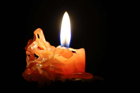 Burning candle in the dark close-upの写真素材