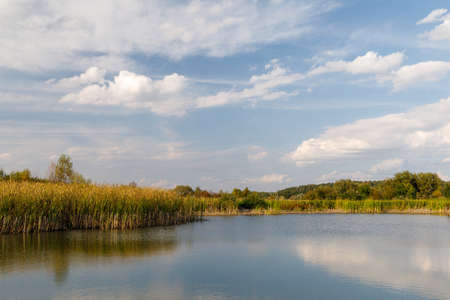 Autumn landscape of beautiful lake and blue skyの写真素材