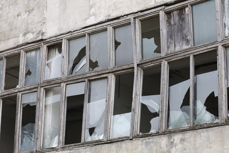 Broken old windows of a factory or houseの写真素材