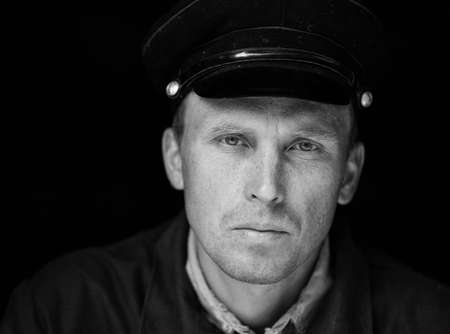 Portrait of a young worker in an old uniformの写真素材