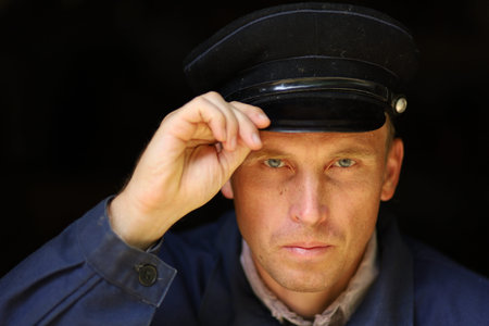 Portrait of a young worker in an old uniformの写真素材