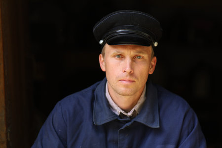 Portrait of a young worker in an old uniformの写真素材