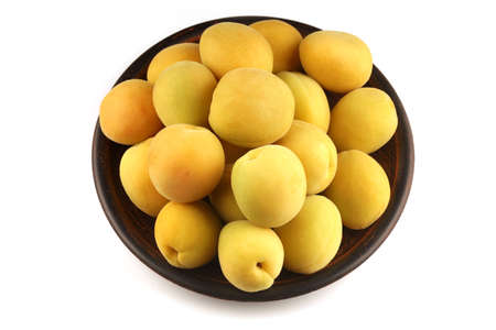 Apricot in a plate white backgroundの写真素材