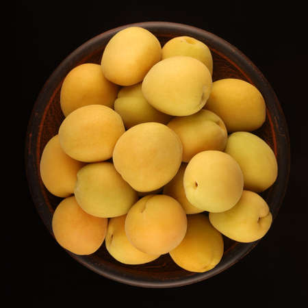Apricot in a plate black backgroundの写真素材