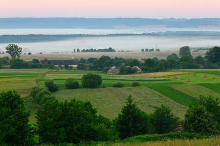 Ukrainian village Verkhobuzh in the morning in the fogの写真素材