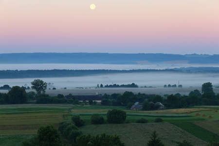 Ukrainian village Verkhobuzh in the morning in the fogの写真素材