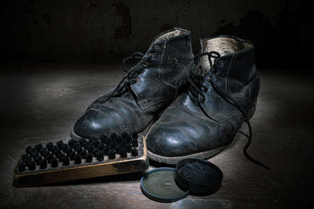 Old black shoes and shoe polishの写真素材