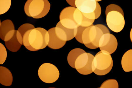 Beautiful yellow round bokeh and black backgroundの写真素材