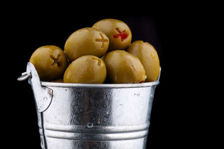 Green olives stuffed in a bucketの写真素材
