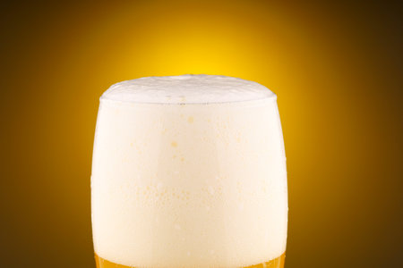 Light unfiltered beer with foamの写真素材
