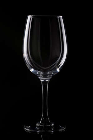 Empty wine glass on black background with beautiful highlightsの写真素材