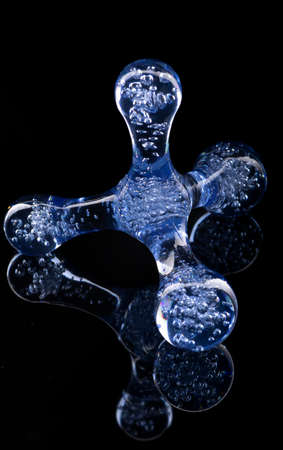 Simple plastic body massager on black backgroundの写真素材