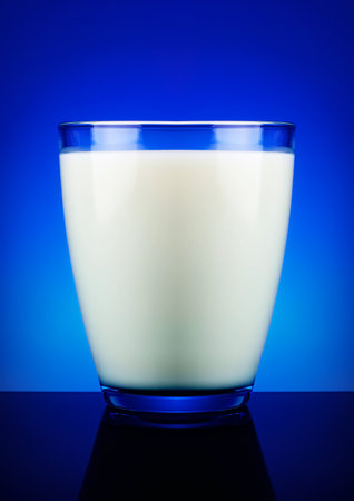Glass of milk and blue backgroundの写真素材