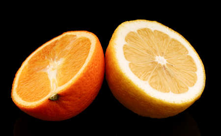 Orange and lemon on black backgroundの写真素材
